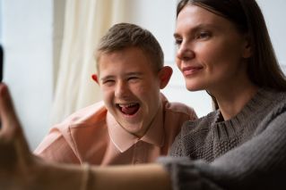 Close-up of a happy child with a wooden backdrop, exuding joy and innocence.